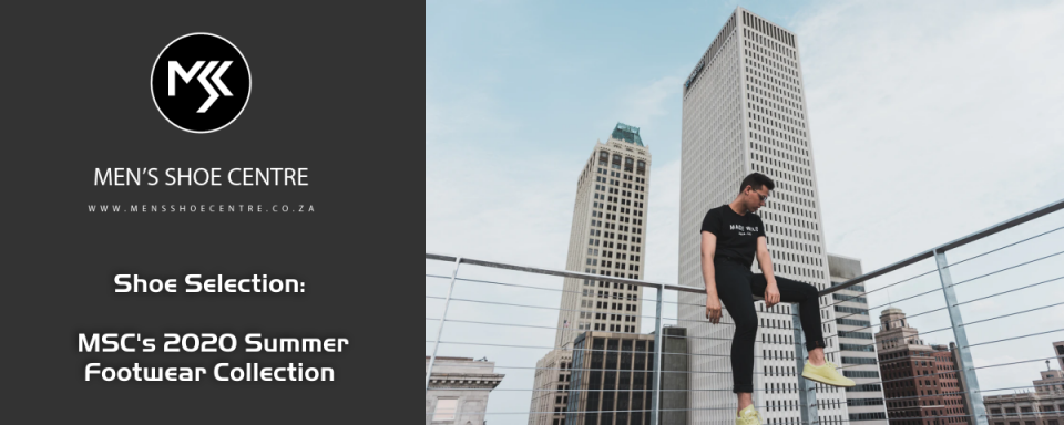 a man sitting on a railing in front of a city skyline